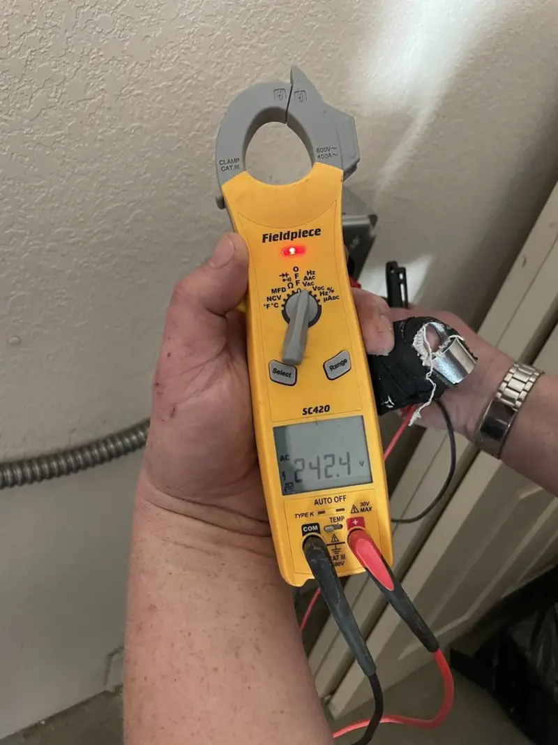 Voltage testing with clamp meter during Recessed Lighting Installation in Eagle Pass